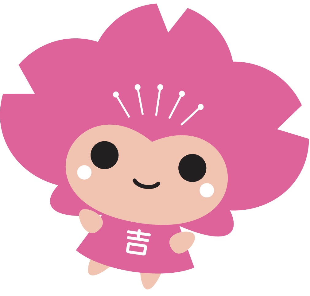 右に傾いた胸に「吉」の文字が書かれたピンク色のキャラクター、ピンクルのイラスト