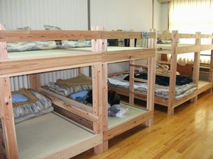 教室で泊まろう!をコンセプトに改修された二段ベッドが多数置かれた宿泊室の写真