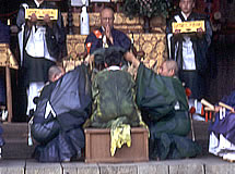 寺の本殿で祈りを捧げる数人の僧侶の写真